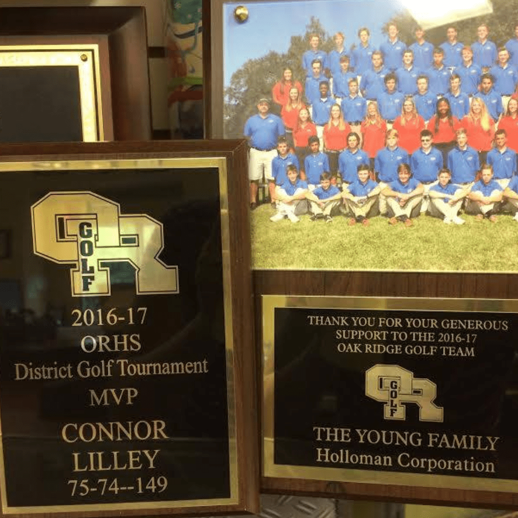 Golden plaques sample with a picture of a golf team on the back