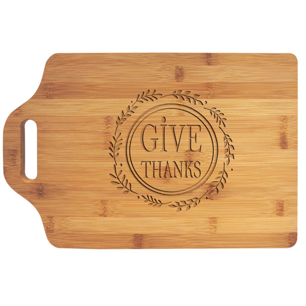 Wooden chopping board with "Give Thanks" written on it